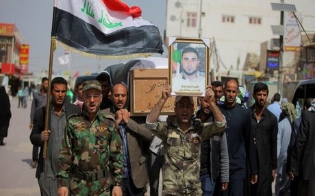 The Shiite Badr Brigade, backed by Iran, at a funeral for a dead fighter. AP photo.