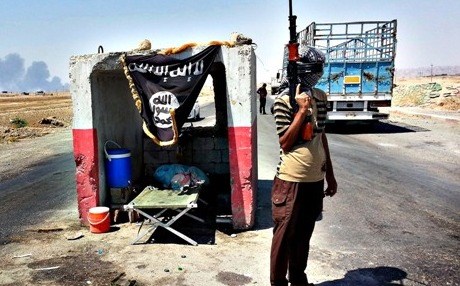 A masked gunman guards an ISIS checkpoint in Iraq. AP file photo.