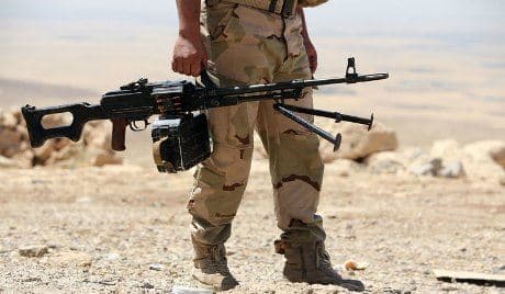 AFP file photo of a Peshmerga fighter taking position with his gun on one of the frontlines against the Islamic State armies.