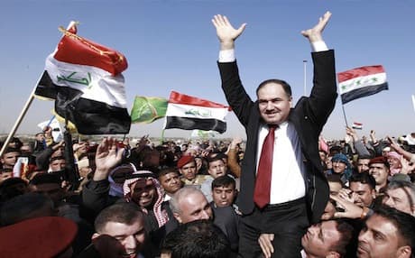 Iraq's Sunni Finance Minister Rafei al-Isawi lifted up his supporters during anti-government demonstrations in Ramadi, Dec 2012. Photo: AP
