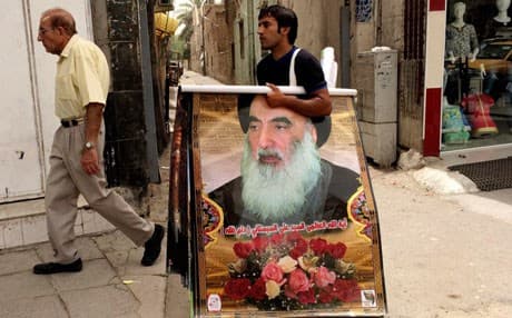An Iraqi vendor sells posters of Shiite spiritual leader Grand Ayatollah Ali al-Sistani, in Baghdad. AP file photo