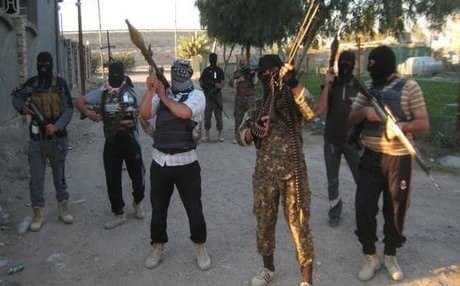 Masked anti-government gunmen in Fallujah. AP file photo.