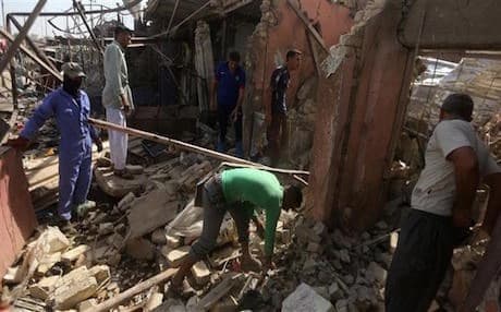 Civilians search through the wreckage of a deadly bombing that struck the town of Khan Bani Saad in Diyala on July 18. Photo: AFP