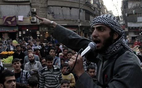 An ISIS member urges citizens of Aleppo to join the organization. AFP Photo.