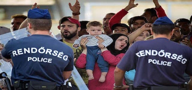 Hungarian police restrain a crowd of migrants in Budapest. Photo: Rudaw