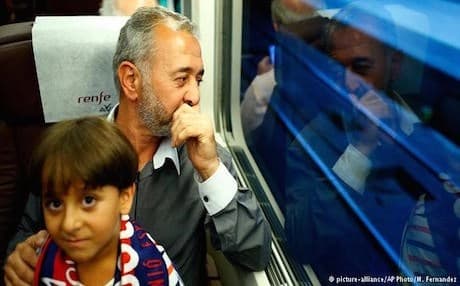 Syrian refugee Osama Abdul Mohsen and his 7-year-old son in Spain. Photo: AP