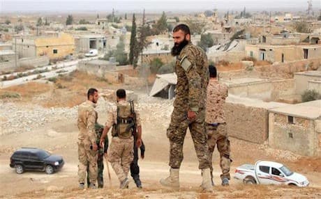 Syrian soldiers in the village of Jabboul in the outskirts of Aleppo following its capture from rebels, October 24, 2015. Photo: AFP