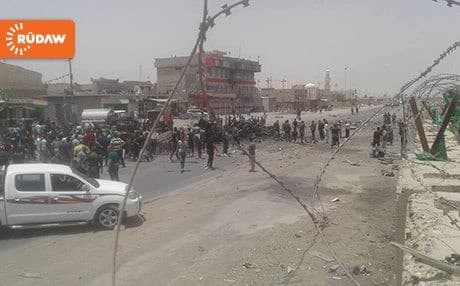 Civilians gathering at the site of an explosion in Khurmatu on June 18, 2016.