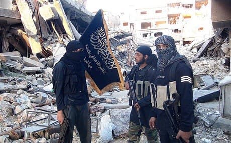 Members of the radical al-Nusra front among destroyed buildings in Yarmouk. AFP photo
