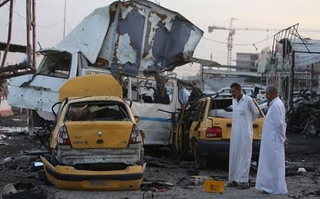 Two men inspect the aftermath of a car bomb attack in Baghdad's Sadr city. AFP file photo