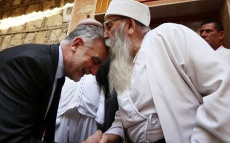 Luis Moreno Ocampo (L), former chief prosecutor of the International Criminal Court, greets Baba Sheikh, Yezidi spiritual leader, in Lalish Temple, during a visit to Duhok on September 1, 2015. Photo: Safin Hamed/AFP