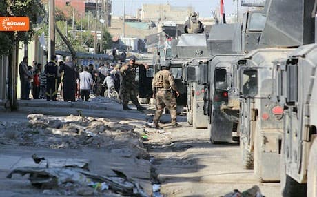Iraqi armed vehicles line up in Mosul's al-Zahra neighborhood.