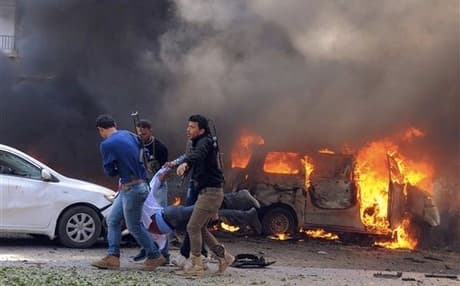 Syrian security forces carry a body from the site of a car bomb in Damascus. Photo: AP