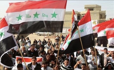 Tikrit protesters display Saddam-era Iraqi flags during a March 2013 demonstration. Photo AFP