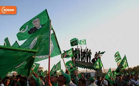 PUK supporters wave their party’s green flag and Talabani's picture during the last election campaign. Photo Rudaw