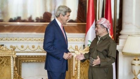 Kerry and Barzani exchange greetings before going into a meeting. Photo: AFP