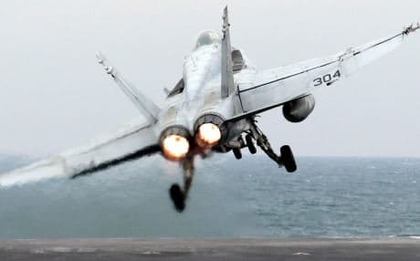 An F/A-18F Super Hornet takes off from the carrier USS George HW Bush in this AP file photo. The carrier is involved in surveillance flights over Syria authorized by President Obama.
