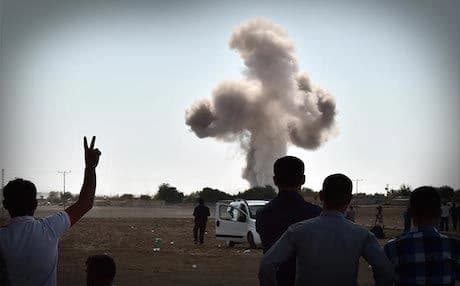 A plume of smoke rises from Kobane after an air strike. Photo: AFP.