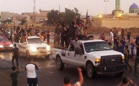 ISIS fighters parade the streets of Mosul after capturing it in June. Photo: AP.