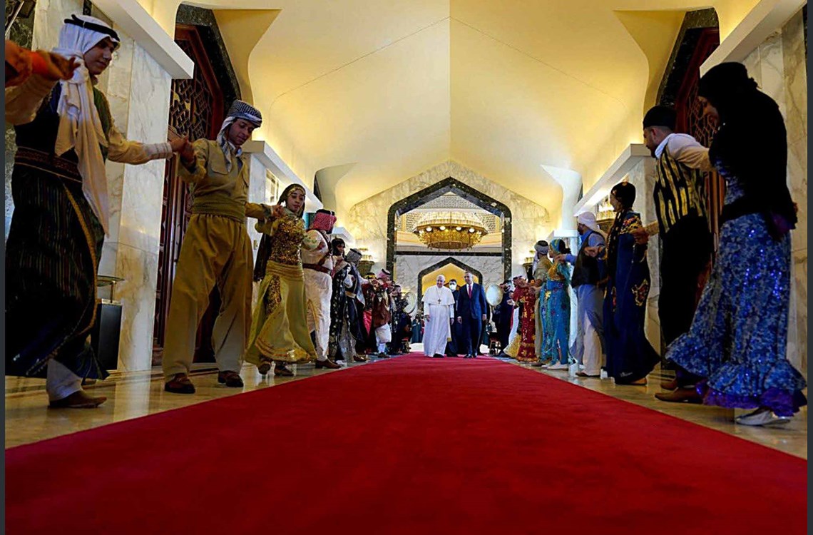 A handout image released by the press office of Iraqi Prime Minister on its Facebook page on March 5, 2021 shows Prime Minister Mustafa al-Kadhimi receiving Pope Francis upon his arrival in the capital Baghdad. Photo: Iraqi Prime Minister's office/ AFP