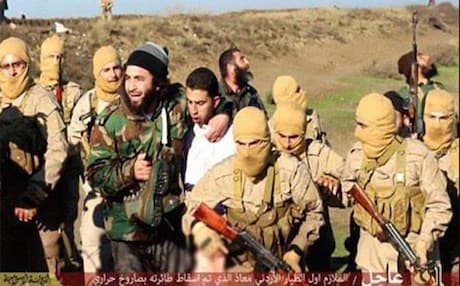 ISIS militants with Jordanian pilot Mouath al-Kasaesbeh shortly after his capture in December.
