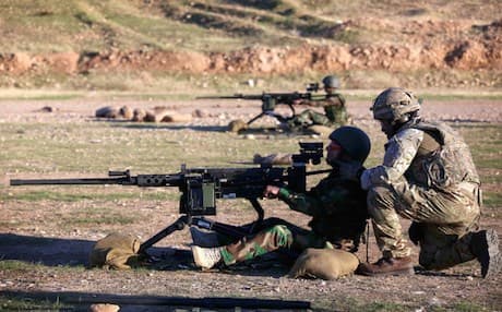 British military advisers instruct Kurdish Peshmerga fighters during a training session at a shooting range on the outskirts of Erbil. Photo: AFP