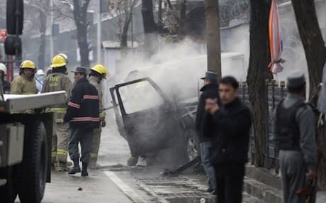  Afghan security personal inspect a damaged vehicle at the site of a suicide attack in Kabul. Photograph: Rahmat Gul/AP