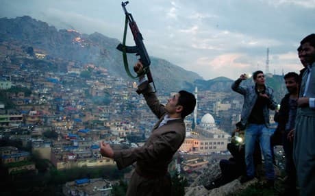 A man fires his rifle in the air during Newroz celebrations in Akre on Friday, photo by Campbell MacDiarmid