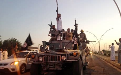 ISIS fighters parade through Mosul in June 2014. AP photo. 