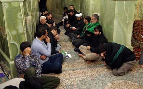 Iranian pilgrims pray inside a Shiite shrine in Samarra. AP file photo. 