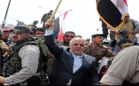 Iraqi Prime Minister Haidar al-Abadi posted a picture of himself online raising an Iraqi flag in Tikrit.
