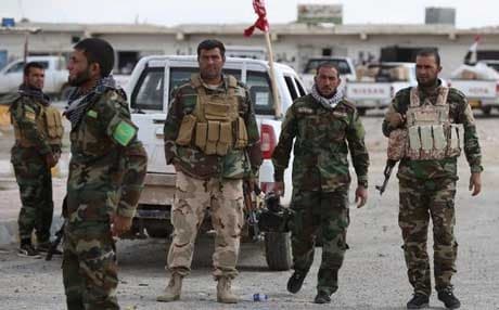 Iraqi Sunni fighters stand at a checkpoint at the entrance of Al-Alam, a flashpoint town north of Tikrit on March 22, 2015. AFP file Photo.