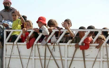 A truck carrying Yazidi children heads for safety in Iraq’s Kurdistan. AFP file Photo. 