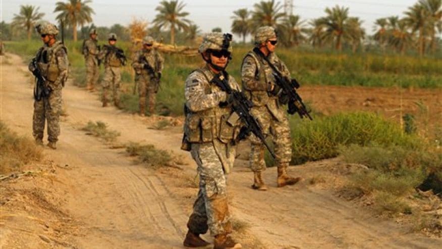 Army soldiers from 1st Battalion, 18th Infantry Regiment walk on a dirt road during an operation in Istaqlal, north of Baghdad, Iraq, Aug. 8.AP file photo. 