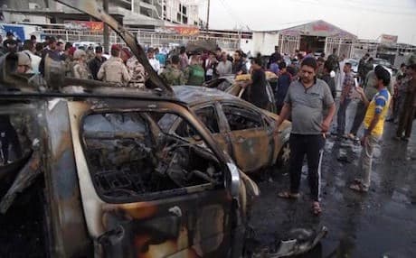 AP File Photo: People and security forces gather at the scene of a car bomb explosion in Habibya in eastern Baghdad, Iraq, Friday, April 17, 2015.