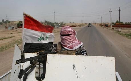 A masked Iraqi policeman near Fallujah, Anbar province. AFP file photo.