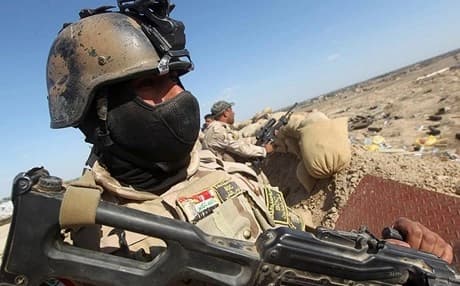 Iraqi soldiers hold a position near Fallujah. AFP file photo.