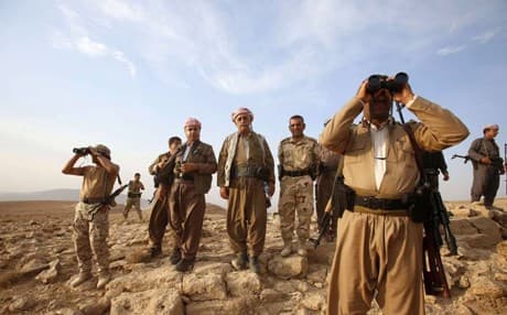 Kurdish peshmerga forces stand guard outside the town of Makhmur. Reuters file photo. 