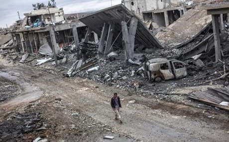 In this January 30, 2015 , a Syrian Kurdish man walks among the rubble in the Syrian city of Kobane.AP file photo.