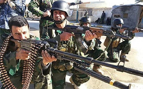 Iraqi soldiers take position in a street of Ramadi. AP file Photo.