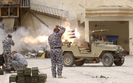 Iraqi forces fire a rocket as a part of an operation to retake the Baiji oil refinery from ISIS. AFP file Photo.