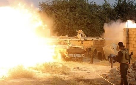 Iraqi fighters from the Shiite Muslim Al-Abbas popular mobilization unit battle Islamic State jihadis in an area surrounding the village of Dujail in the Salaheddin province, north of Baghdad, on May 26, 2015 — AP Photo.