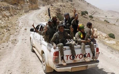  Kurdish fighters of the YPG, flash victory signs as they sit on their pickup on their way to battle against the Islamic State, near Kezwan mountain, northeast Syria — AP File Photo.