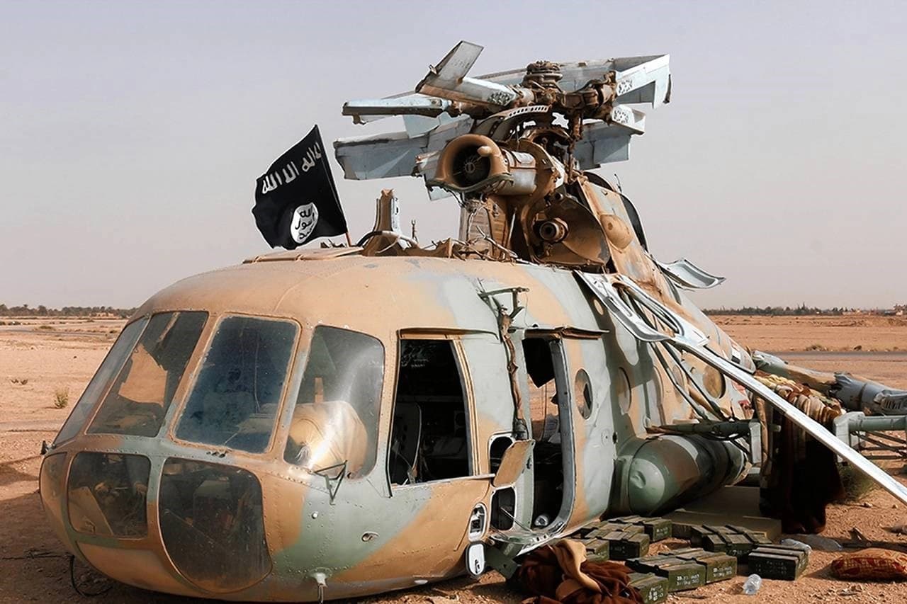 Islamic State militants closed in on Aleppo and a key supply route from Turkey. The group marked a damaged helicopter, above, in Palmyra. AP file photo. 