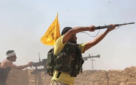 Iraqi fighters fire at Islamic State militants near the Baiji refinery. AFP file photo