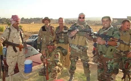 Ron Hollandi, wearing sunglasses, posing with fellow Peshmerga. Photo: Rudaw.