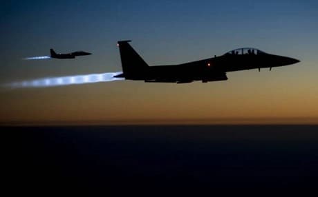 A pair of US Air Force F-15E Strike Eagle fighter jets fly over Kurdistan region after conducting airstrikes in Syria. AP file photo