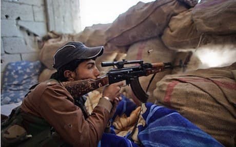 A YPG fighter takes position against ISIS militants in Syria. AFP file photo