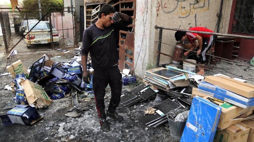 Iraqis clean up the site of a car bomb near restaurants and shop in Palestine Street in eastern Baghdad, Iraq, Wednesday, June 10, 2015. On Tuesday night, a series of bombings targeting public places and Iraqi security forces killing and wounding civilians.Photo: AP. 