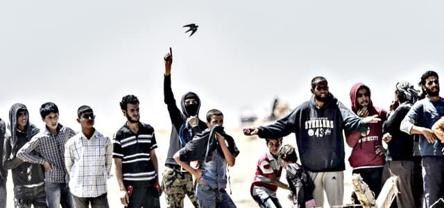 Kurdish refugees from Gire Spi (Tal Abayd) wait near Turkish border. AFP file photo